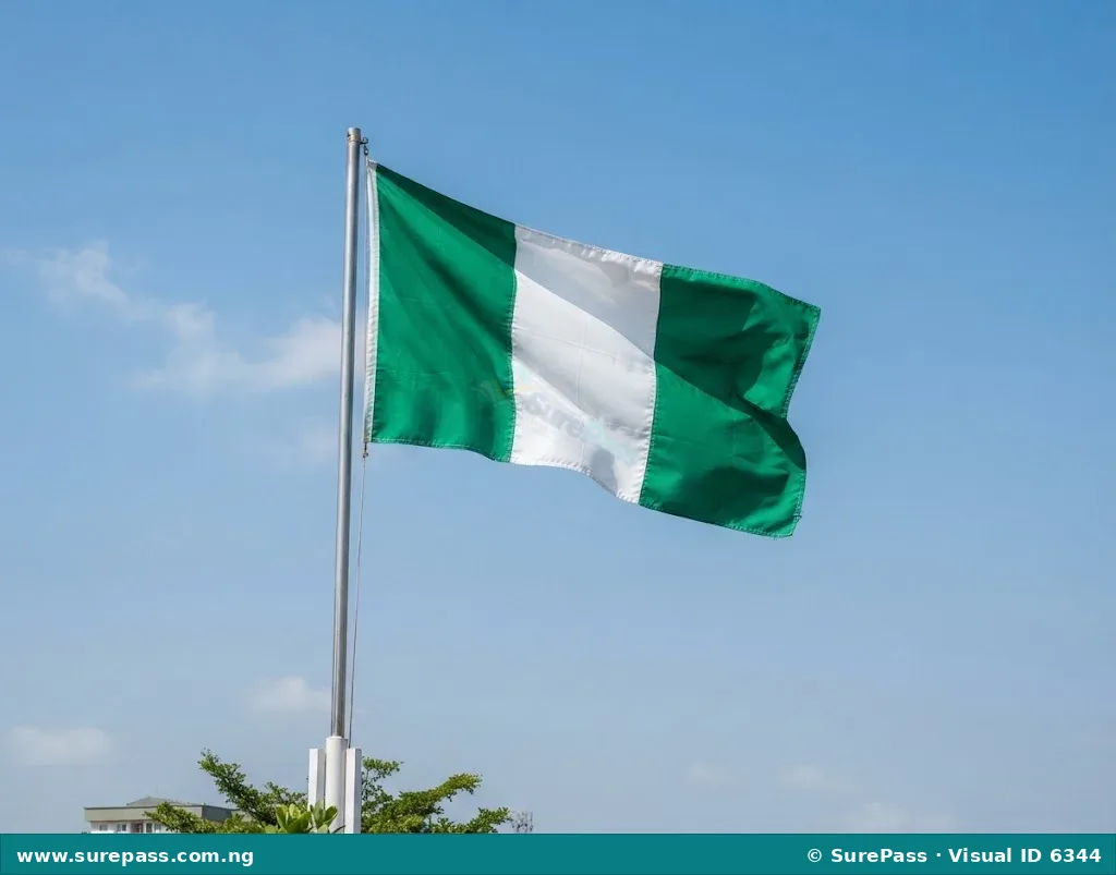 The green-white-green national flag of Nigeria waving on a flagpole.