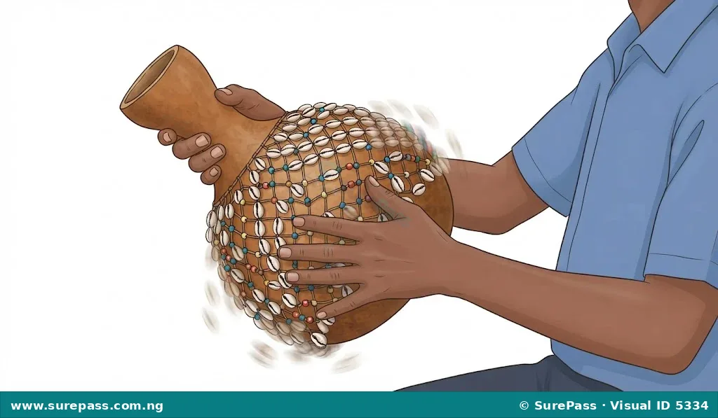 A person's hands demonstrating how to play a shekere by holding its neck and striking its base.